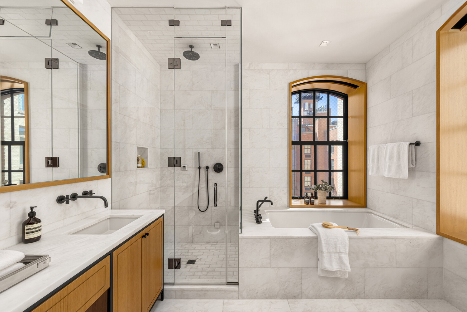 36 Bleecker Street, Unit 5A Manhattan, NY 10012 - Photo 27 of 39 a bathroom with a tub sink and mirror