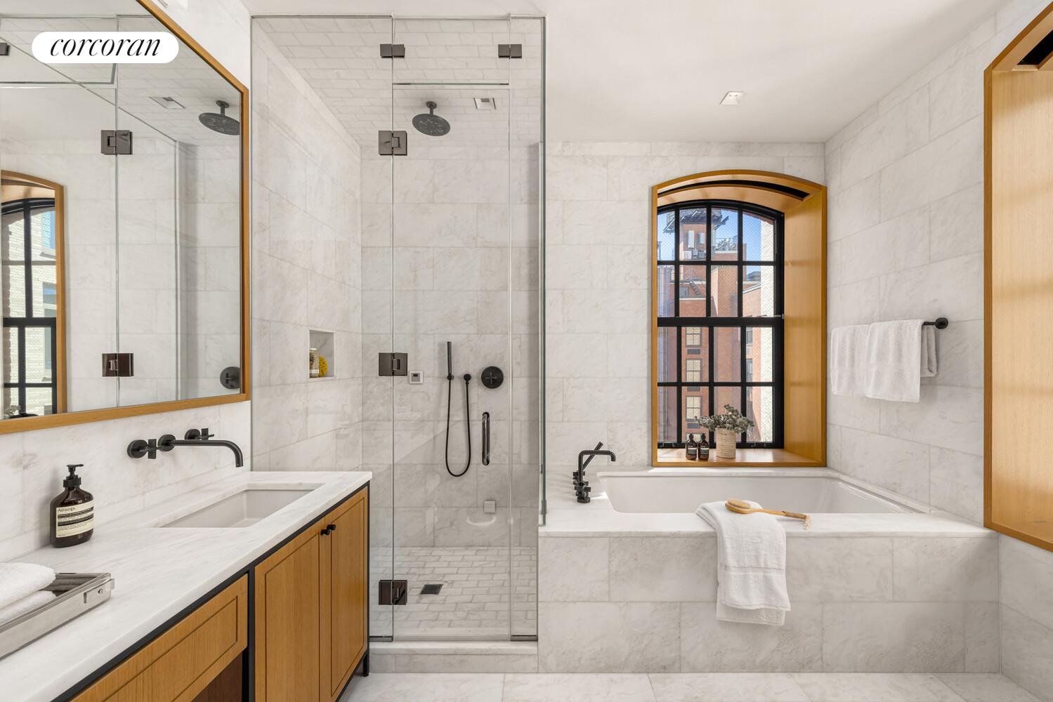36 Bleecker Street, Unit 5A Manhattan, NY 10012 - Photo 8 of 39 a bathroom with a tub sink and mirror