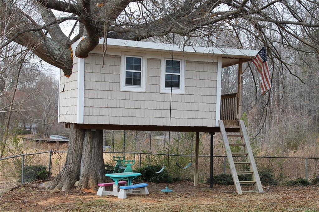 4335 Beaty Road Gastonia, NC 28056 - Photo 21 of 22 a view of a chair and table in the back yard of the house