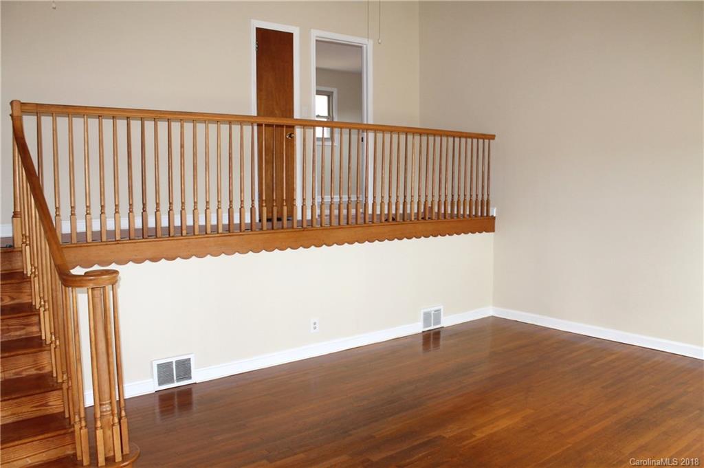 4335 Beaty Road Gastonia, NC 28056 - Photo 4 of 22 a view of a hallway with wooden floor and a window