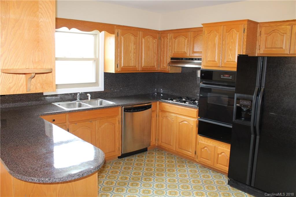 4335 Beaty Road Gastonia, NC 28056 - Photo 5 of 22 a kitchen with stainless steel appliances granite countertop a sink and a stove
