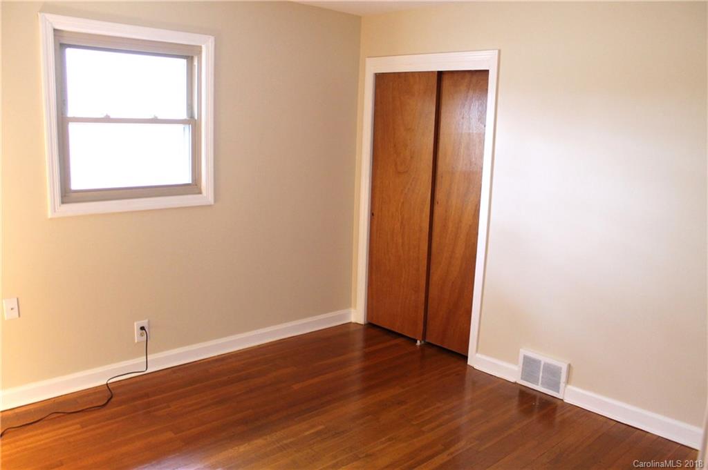 4335 Beaty Road Gastonia, NC 28056 - Photo 8 of 22 an empty room with wooden floor and windows