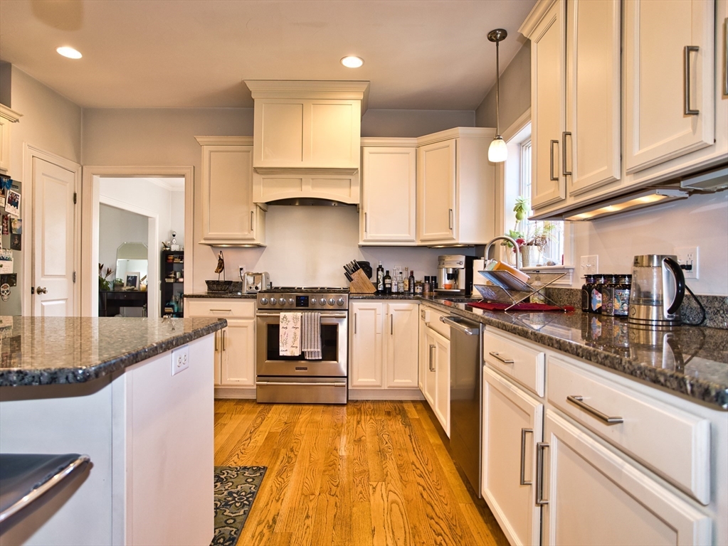 9 Brookfield Lane Bellingham, MA 02019 - Photo 12 of 40 a kitchen with granite countertop white cabinets and white appliances