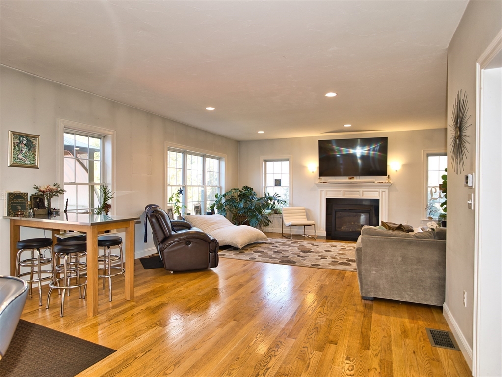 9 Brookfield Lane Bellingham, MA 02019 - Photo 16 of 40 a living room with furniture a fireplace and a flat screen tv