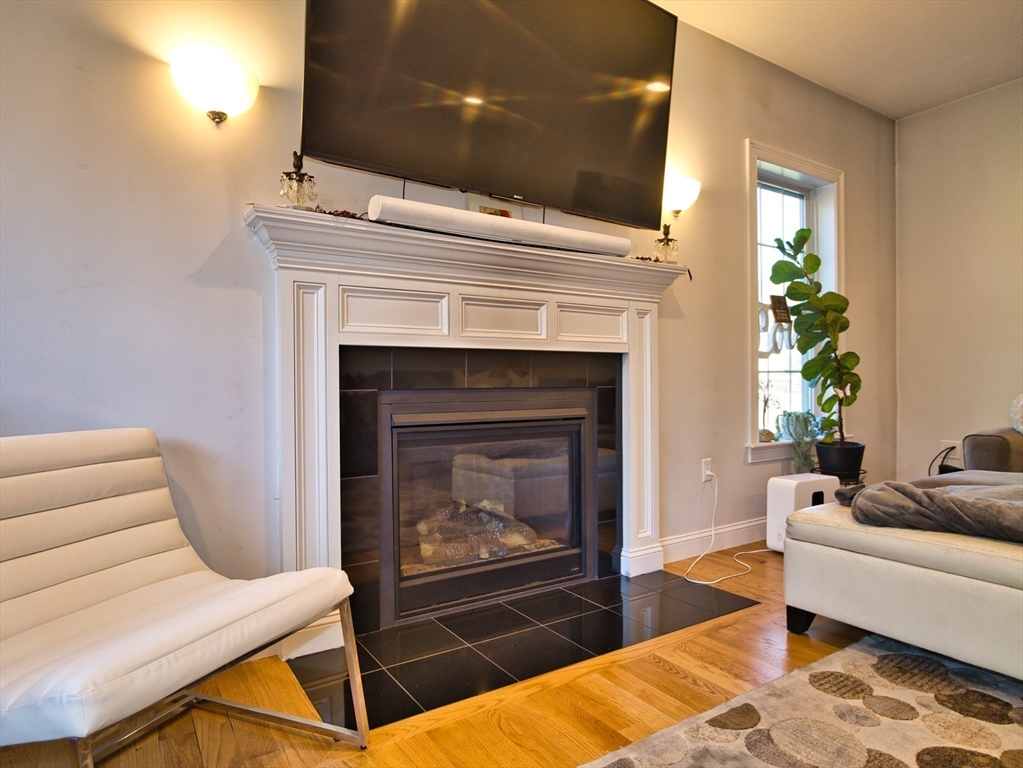9 Brookfield Lane Bellingham, MA 02019 - Photo 17 of 40 a living room with furniture and a fireplace