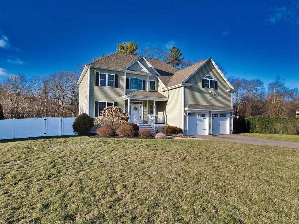 9 Brookfield Lane Bellingham, MA 02019 - Photo 2 of 40 a front view of a house with a yard