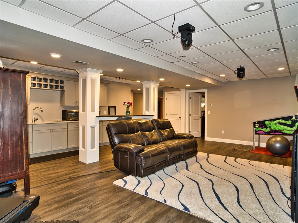 9 Brookfield Lane Bellingham, MA 02019 - Photo 29 of 40 a spacious bedroom with a bed and a chandelier