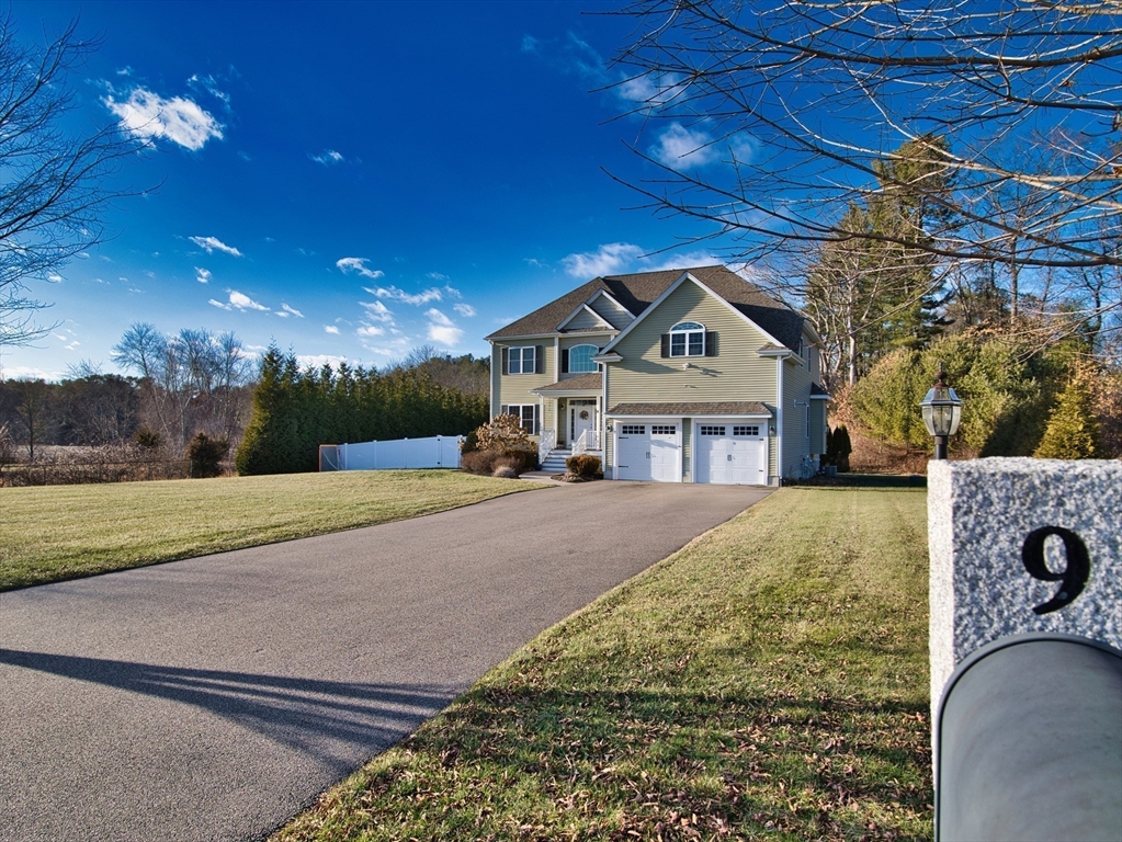 9 Brookfield Lane Bellingham, MA 02019 - Photo 3 of 40 a front view of a house with a yard