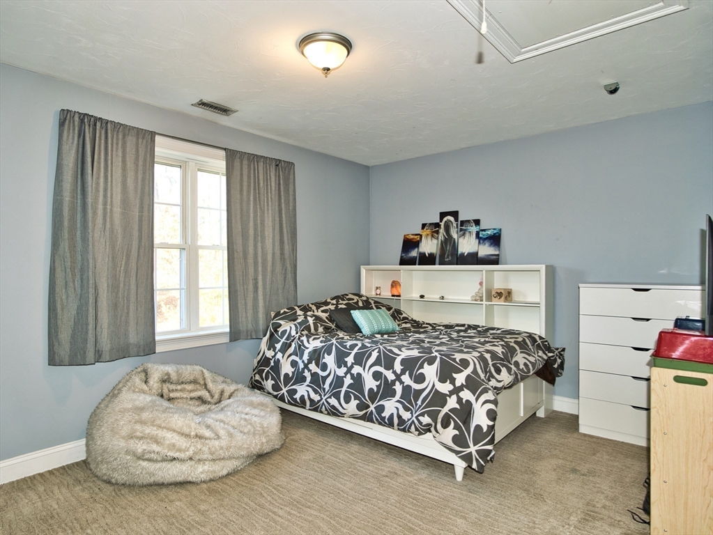 9 Brookfield Lane Bellingham, MA 02019 - Photo 37 of 40 a bedroom with a bed and a window