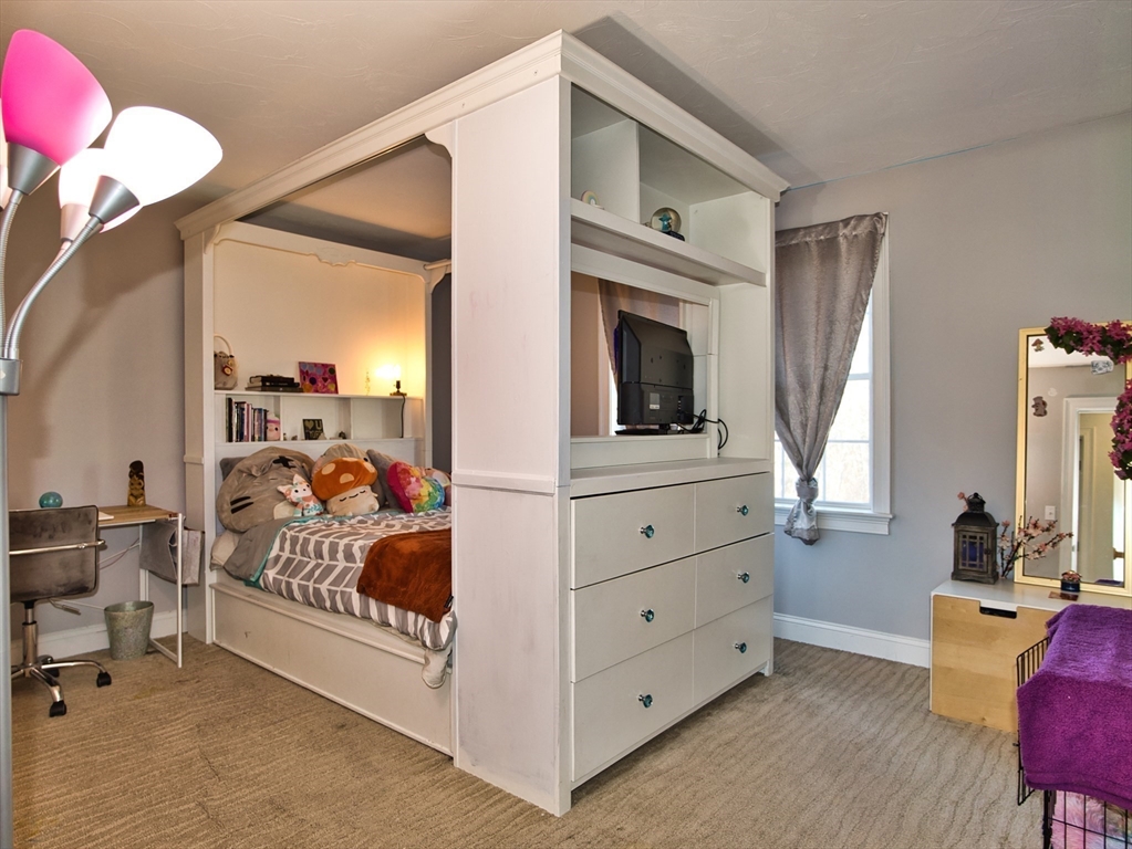 9 Brookfield Lane Bellingham, MA 02019 - Photo 38 of 40 a bed room with a bed and a television