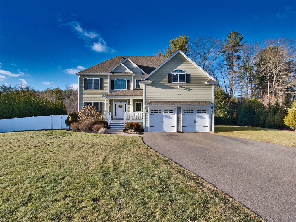 9 Brookfield Lane Bellingham, MA 02019 - Photo 4 of 40 a front view of a house with yard and garage