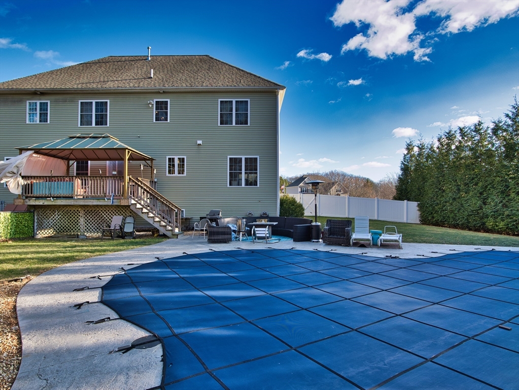 9 Brookfield Lane Bellingham, MA 02019 - Photo 9 of 40 a front view of a house with a yard and potted plants