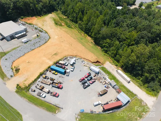 an aerial view of a house a yard and mountain view in back