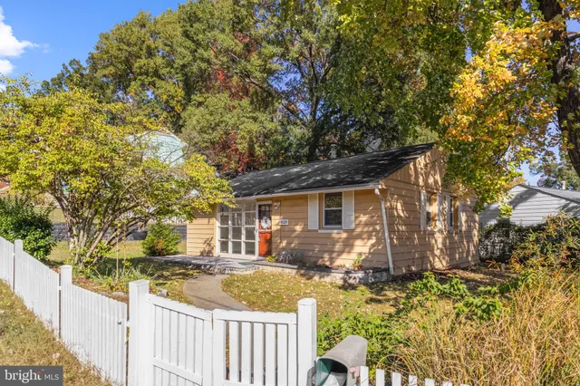 a view of a house with a wooden fence