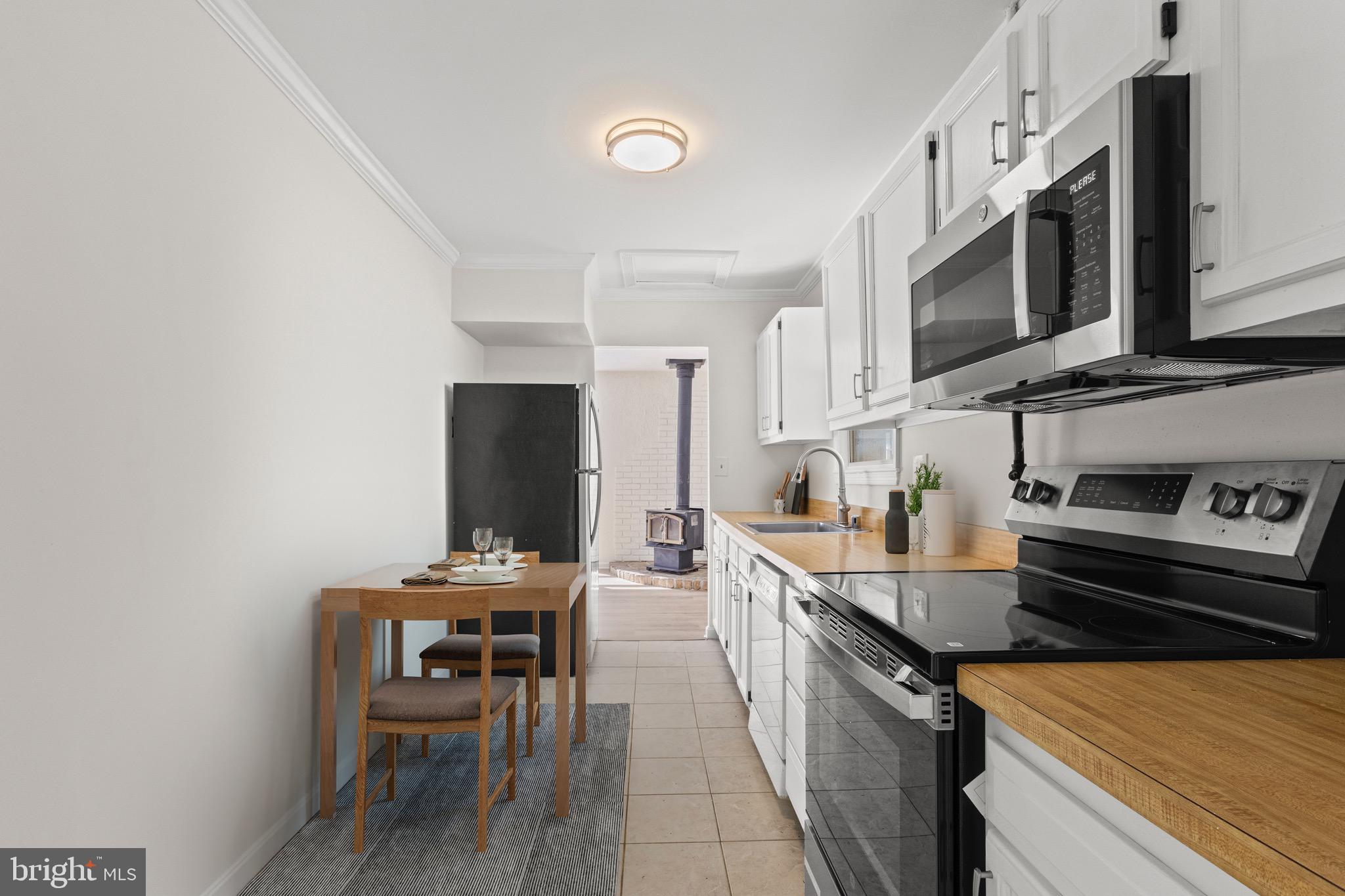 5120 Kenesaw Street College Park, MD 20740 - Photo 12 of 37 a kitchen with stainless steel appliances a stove a sink a microwave and a refrigerator