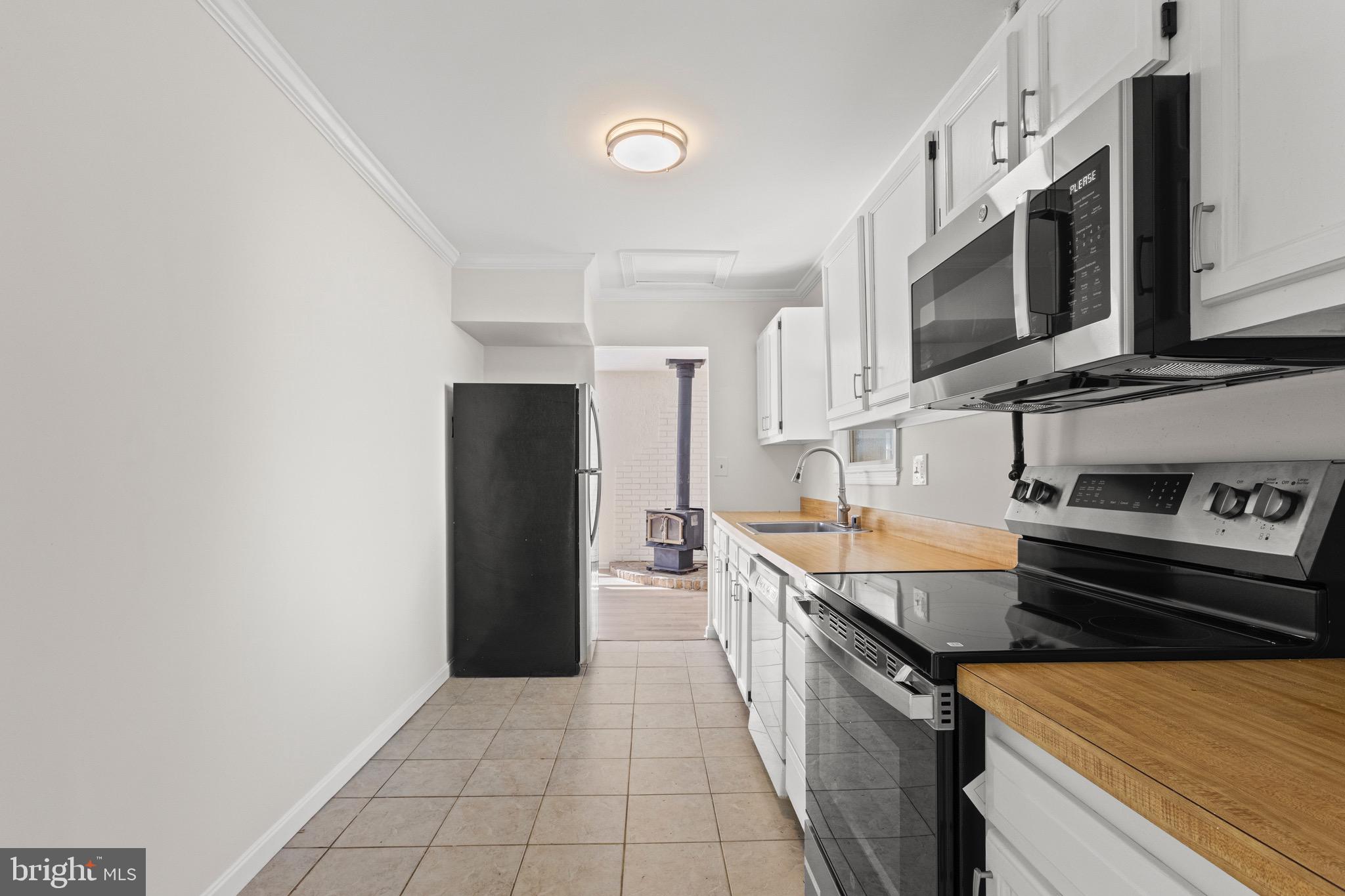5120 Kenesaw Street College Park, MD 20740 - Photo 13 of 37 a kitchen with stainless steel appliances granite countertop a refrigerator and a stove top oven