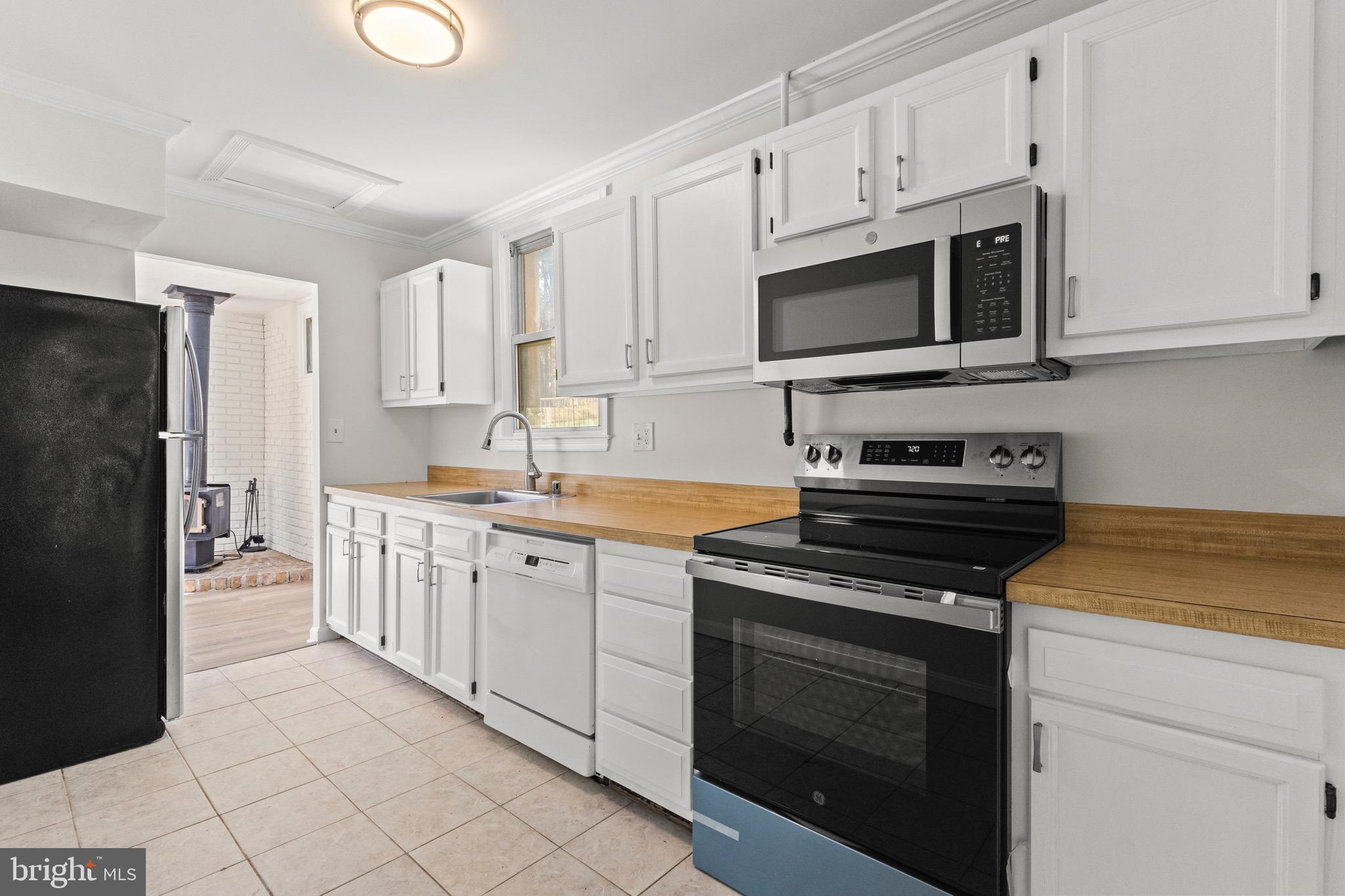 5120 Kenesaw Street College Park, MD 20740 - Photo 14 of 37 a kitchen with stainless steel appliances granite countertop grey cabinets a stove a sink and a microwave