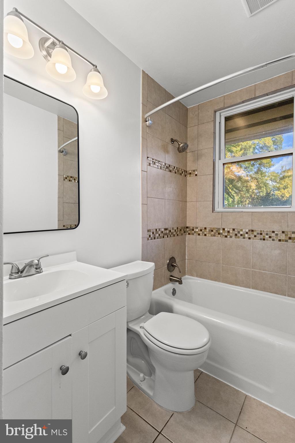 5120 Kenesaw Street College Park, MD 20740 - Photo 21 of 37 a bathroom with a toilet a sink a mirror a bathtub and vanity