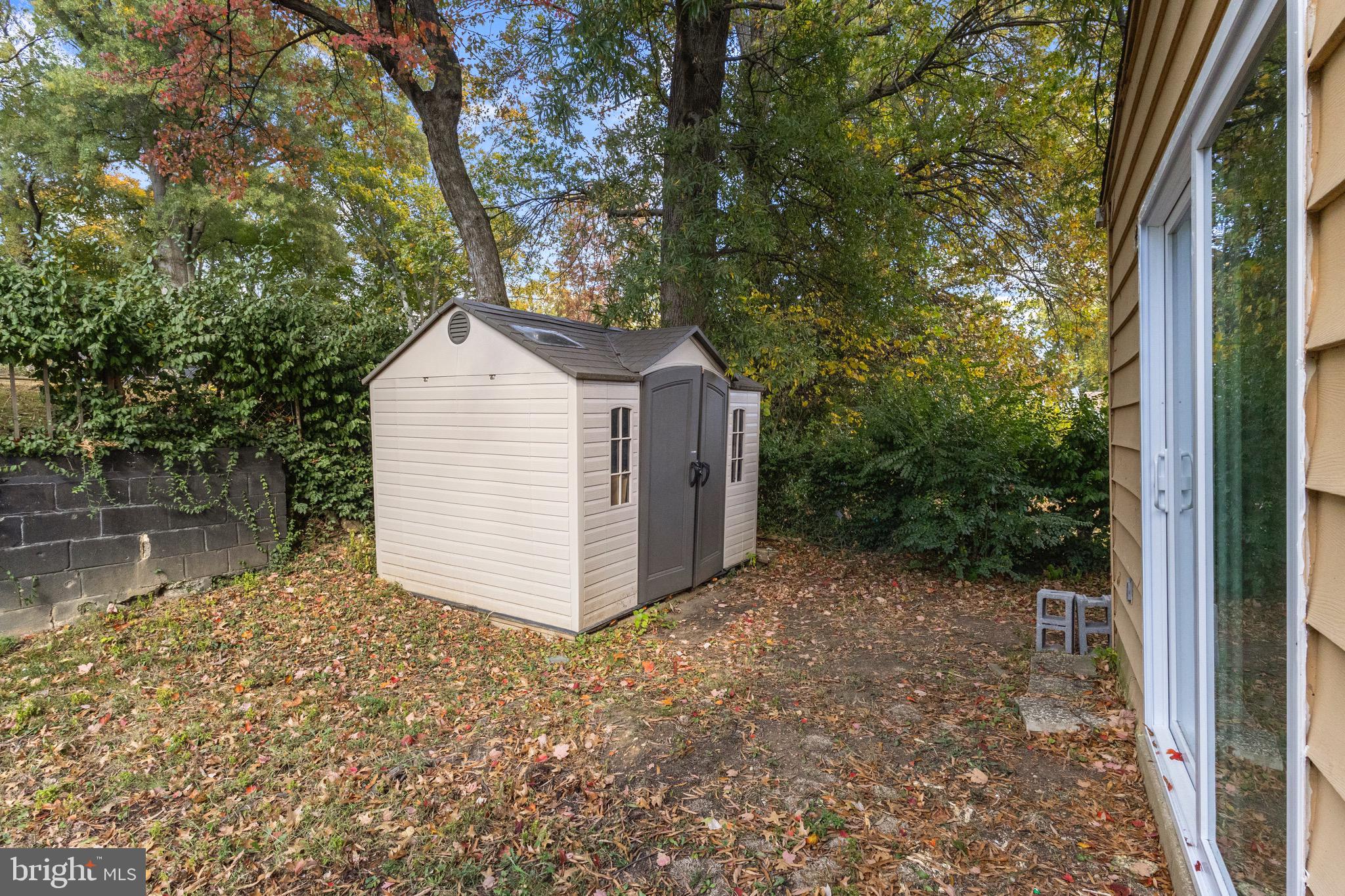 5120 Kenesaw Street College Park, MD 20740 - Photo 28 of 37 a view of a small house with a large tree and wooden fence