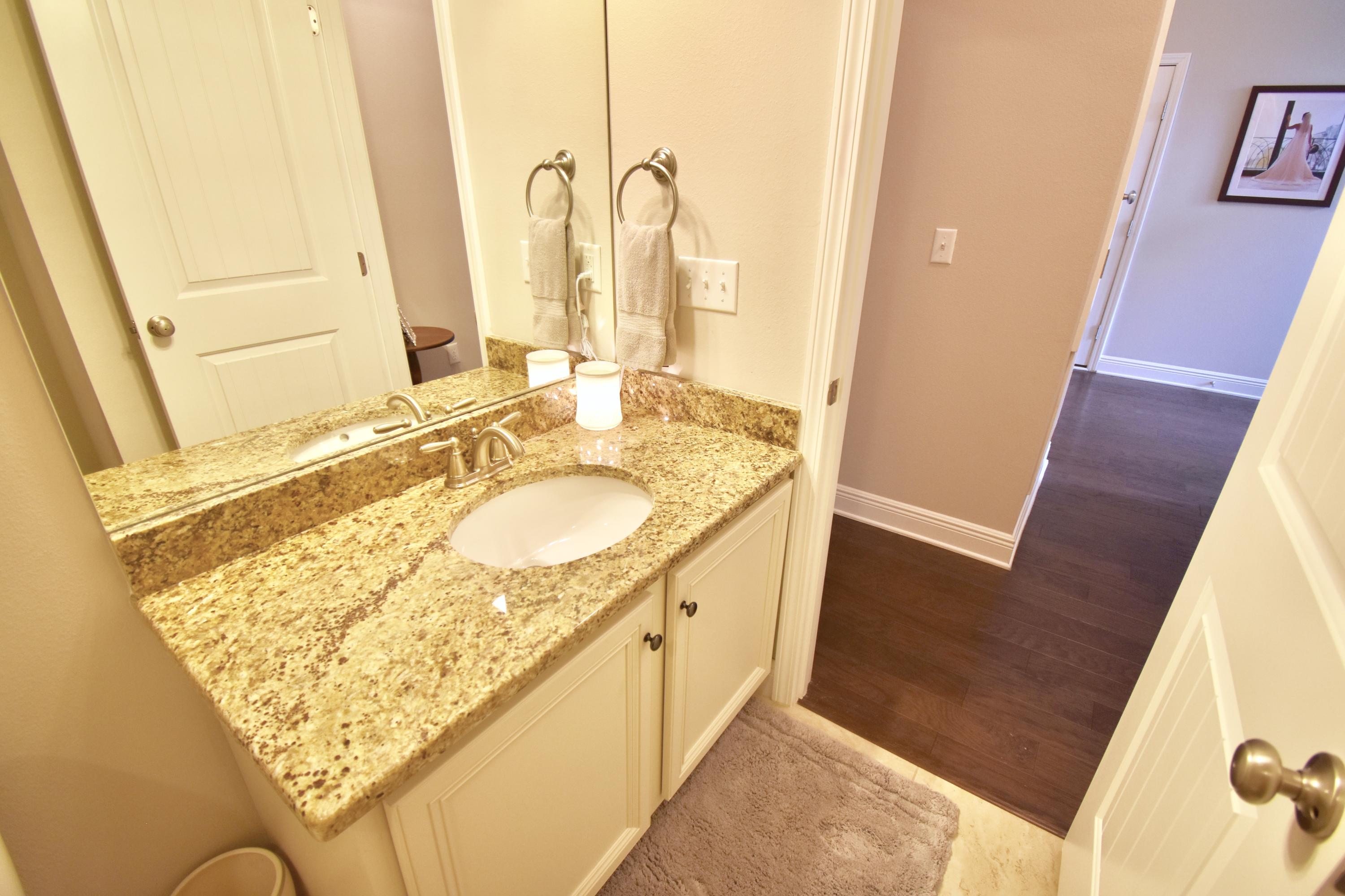 685 Cocobolo Drive Santa Rosa Beach, FL 32459 - Photo 13 of 16 a bathroom with a granite countertop sink and a mirror