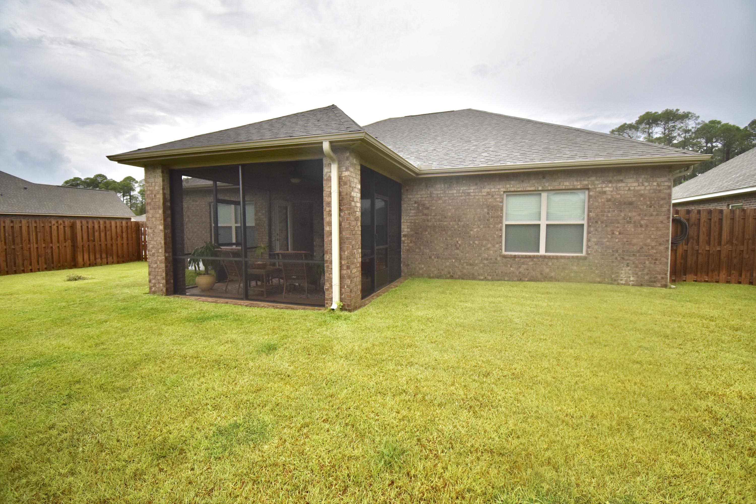685 Cocobolo Drive Santa Rosa Beach, FL 32459 - Photo 16 of 16 a view of a house with a yard