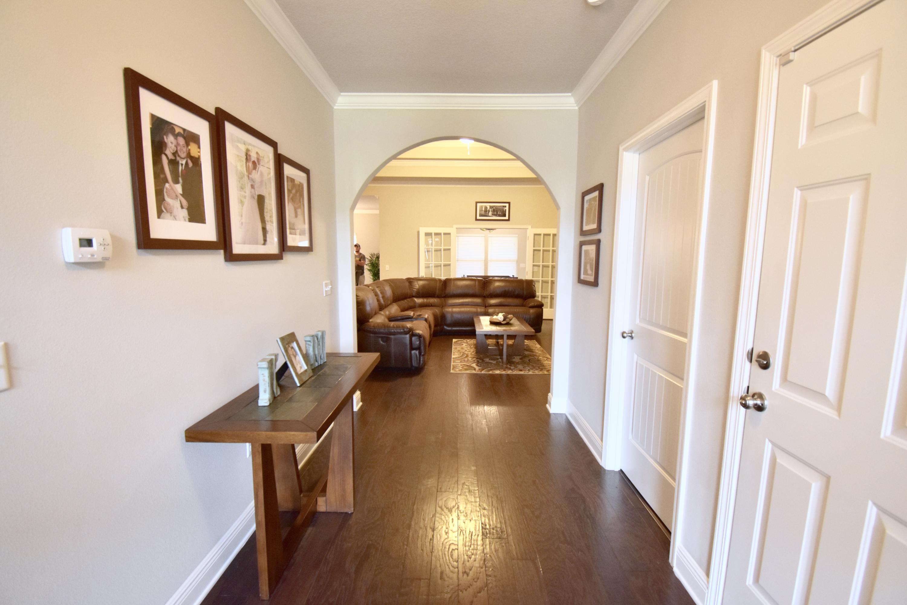 685 Cocobolo Drive Santa Rosa Beach, FL 32459 - Photo 2 of 16 a view of a hallway with wooden floor and furniture