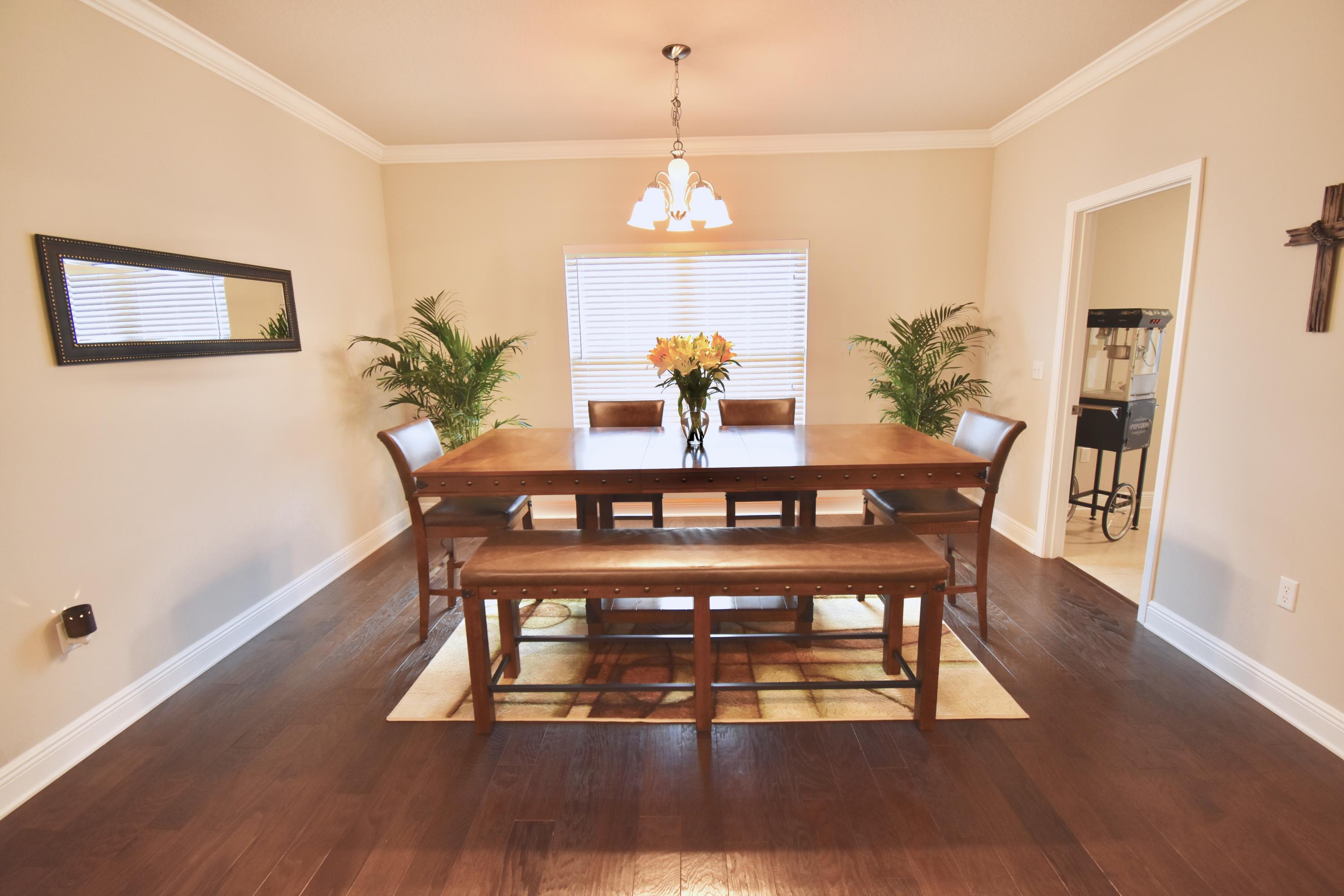 685 Cocobolo Drive Santa Rosa Beach, FL 32459 - Photo 6 of 16 a view of a dining room with furniture wooden floor and a chandelier