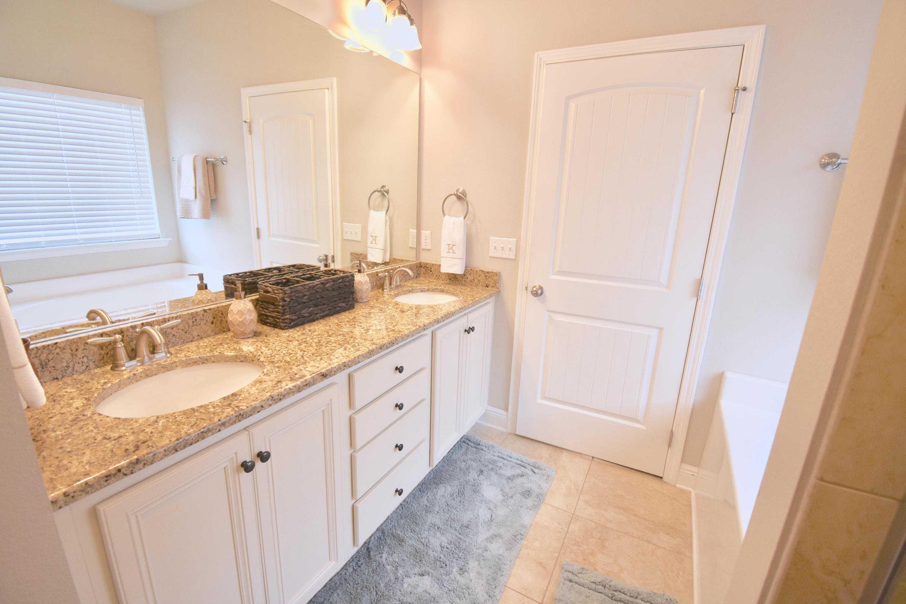 685 Cocobolo Drive Santa Rosa Beach, FL 32459 - Photo 10 of 16 a bathroom with a granite countertop sink and a mirror