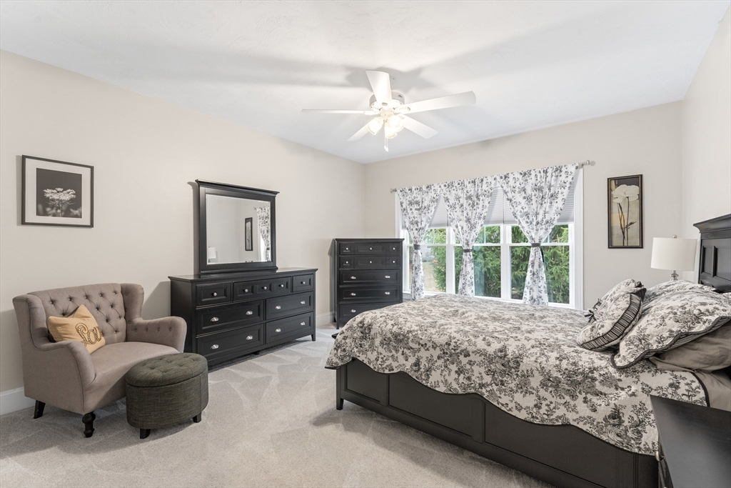 4 Hawthorne Path, Unit 4 Milford, MA 01757 - Photo 15 of 28 a bedroom with a bed and a couch