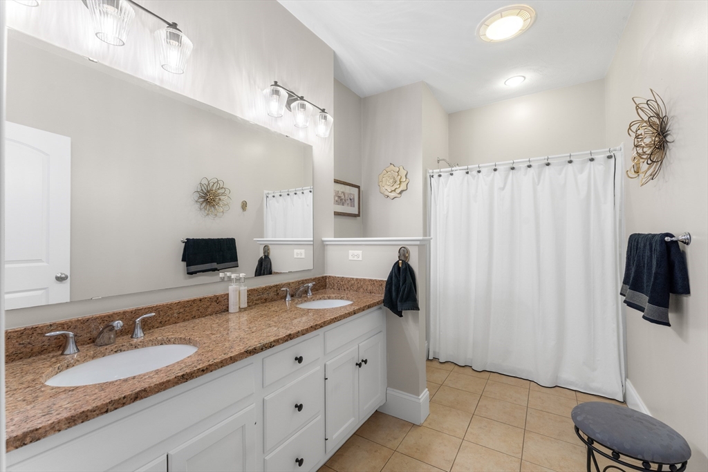 4 Hawthorne Path, Unit 4 Milford, MA 01757 - Photo 16 of 28 a spacious bathroom with double vanity and a mirror