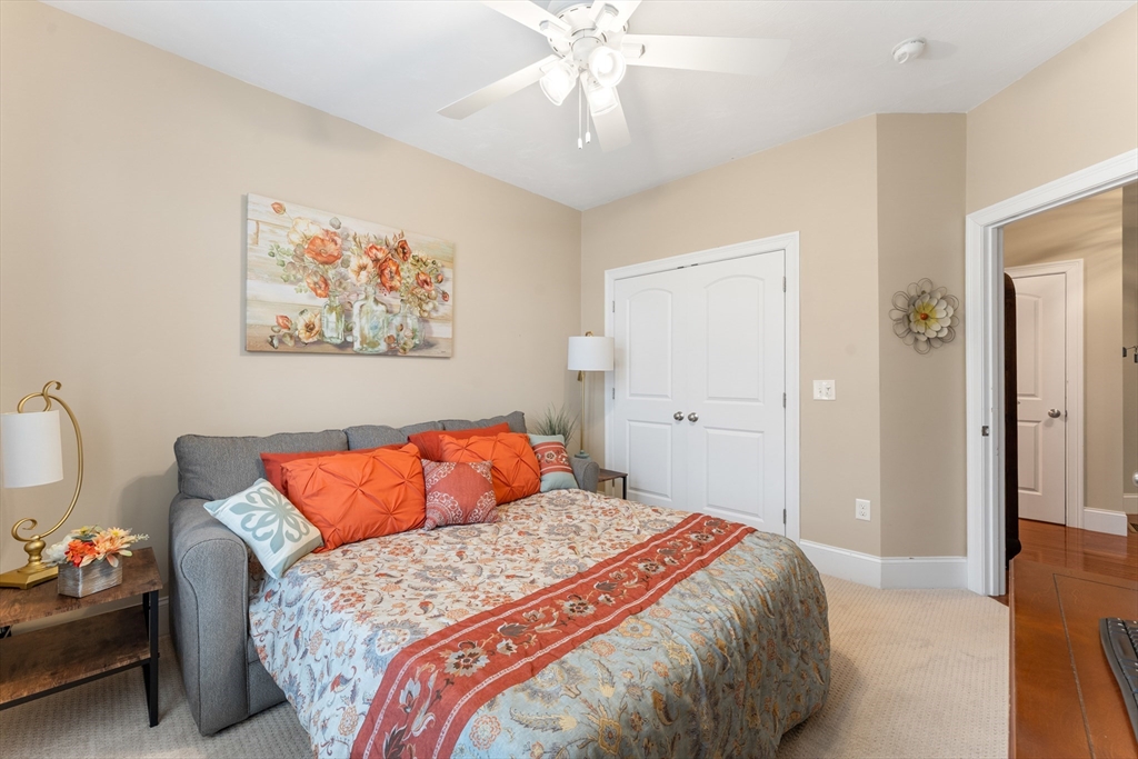 4 Hawthorne Path, Unit 4 Milford, MA 01757 - Photo 19 of 28 a bedroom with a bed and a chandelier