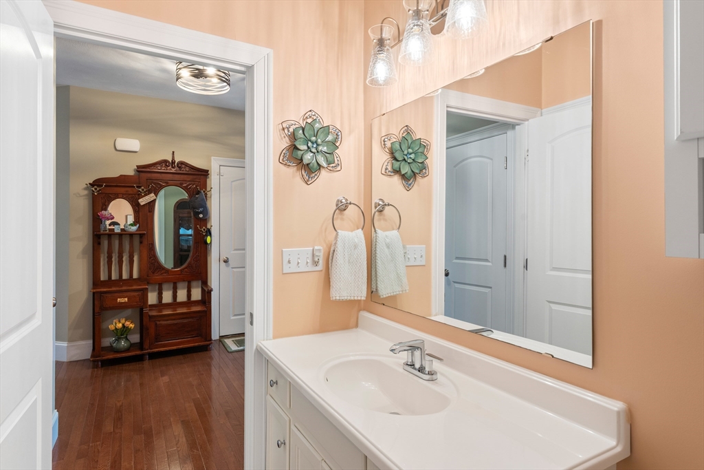 4 Hawthorne Path, Unit 4 Milford, MA 01757 - Photo 21 of 28 a bathroom with a sink and a mirror