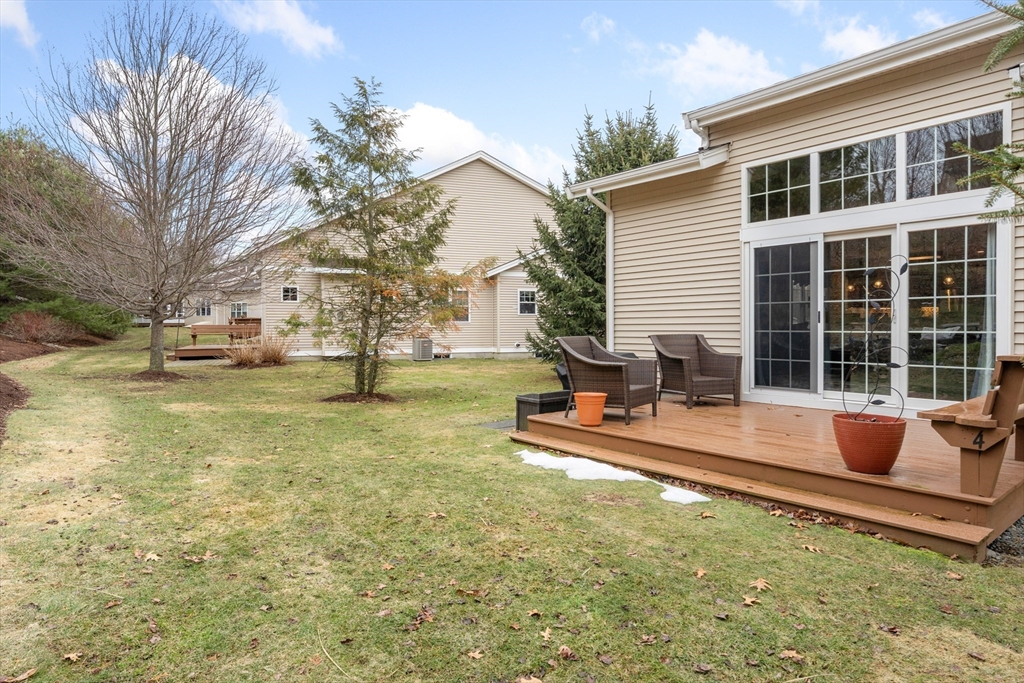 4 Hawthorne Path, Unit 4 Milford, MA 01757 - Photo 22 of 28 a view of a house with backyard porch and sitting area