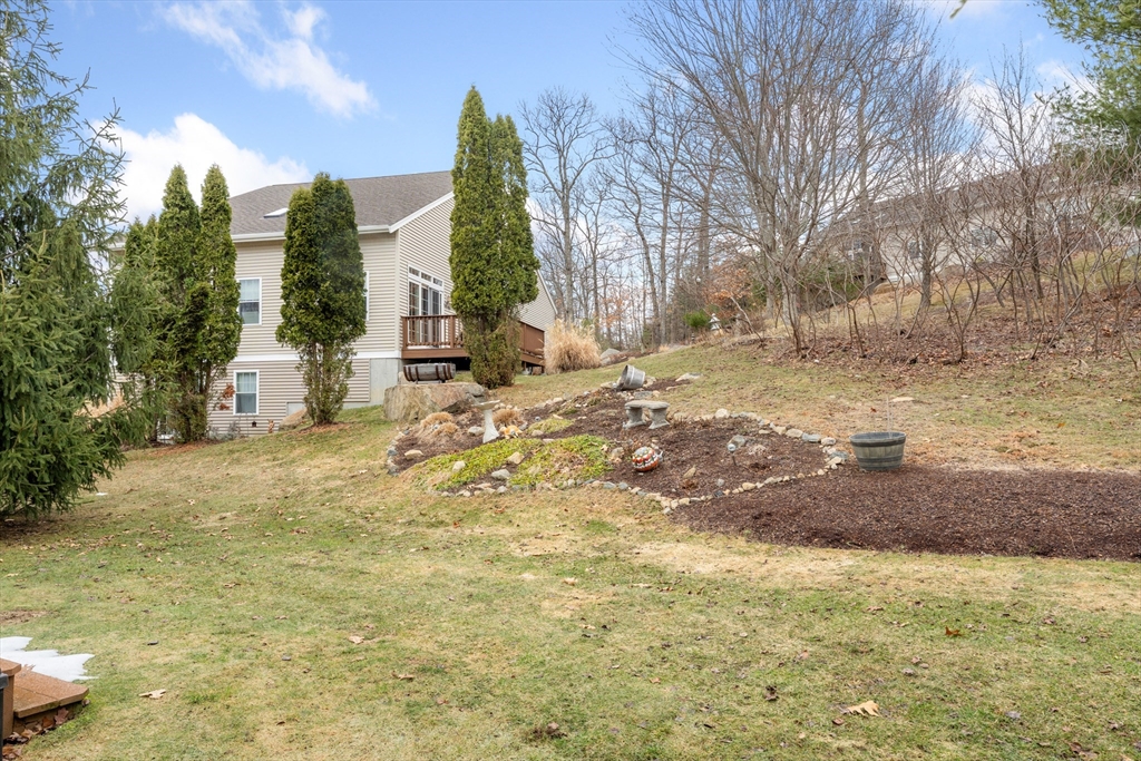 4 Hawthorne Path, Unit 4 Milford, MA 01757 - Photo 26 of 28 a view of a yard with a tree