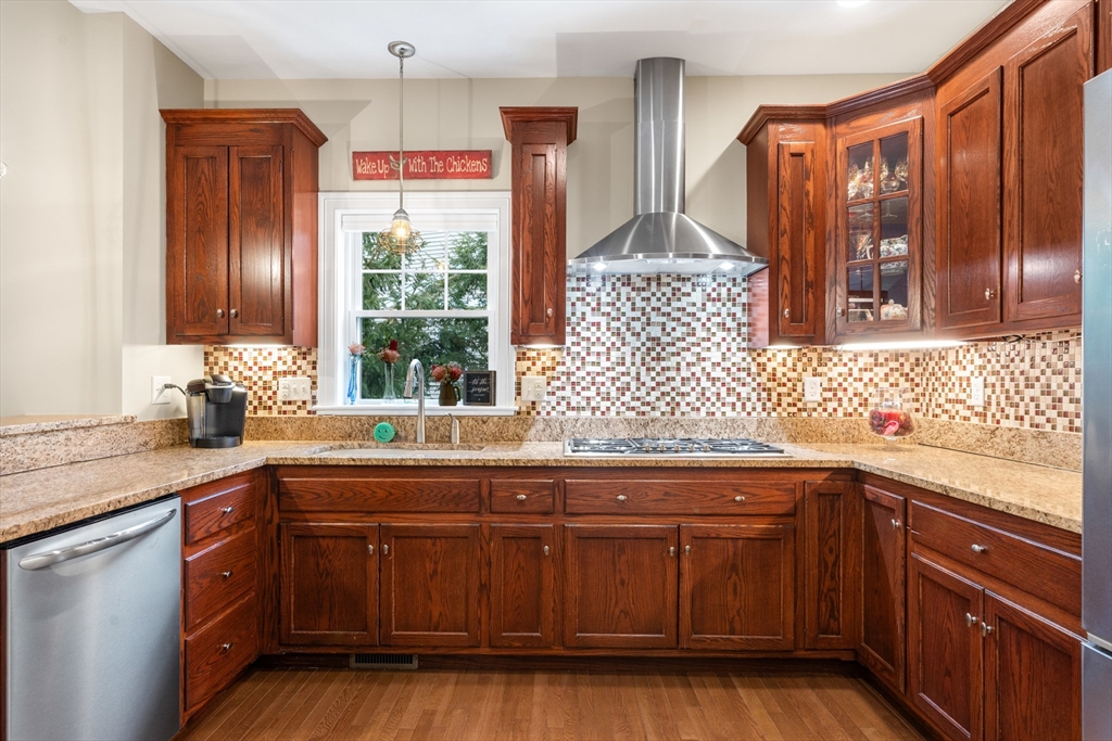 4 Hawthorne Path, Unit 4 Milford, MA 01757 - Photo 4 of 28 a kitchen with stainless steel appliances granite countertop wooden cabinets a sink and dishwasher