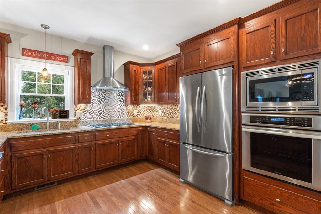 4 Hawthorne Path, Unit 4 Milford, MA 01757 - Photo 5 of 28 a kitchen with stainless steel appliances granite countertop a refrigerator and a sink