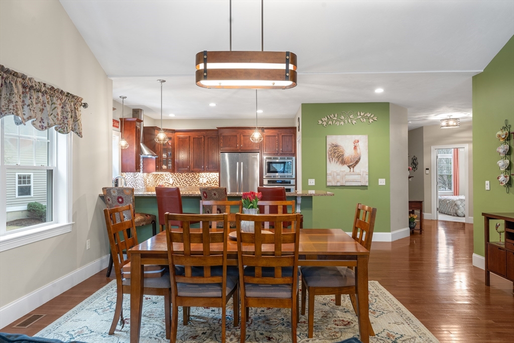 4 Hawthorne Path, Unit 4 Milford, MA 01757 - Photo 9 of 28 a view of a dining room with furniture window and wooden floor