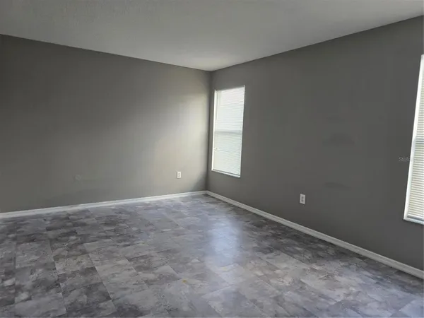 an empty room with windows and closet