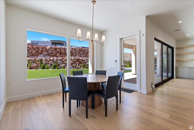 1192 East Corral Way Washington, UT 84780 - Photo 19 of 81 Dining area featuring a contemporary chandelier, wood-finish flooring, and large windows