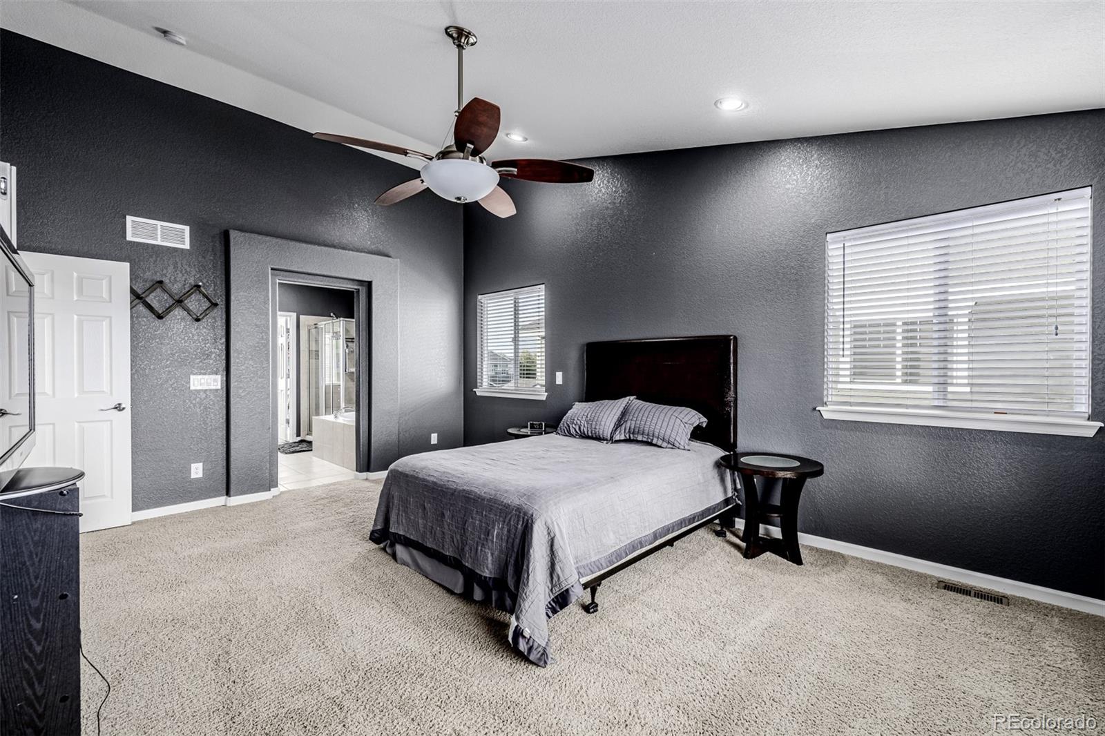 139 Muscovey Lane Johnstown, CO 80534 - Photo 18 of 49 a spacious bedroom with a bed and a chandelier