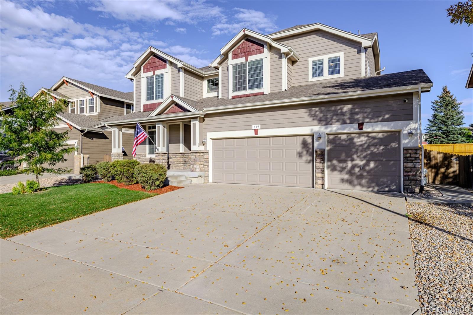 139 Muscovey Lane Johnstown, CO 80534 - Photo 2 of 49 a front view of a house with a yard and garage