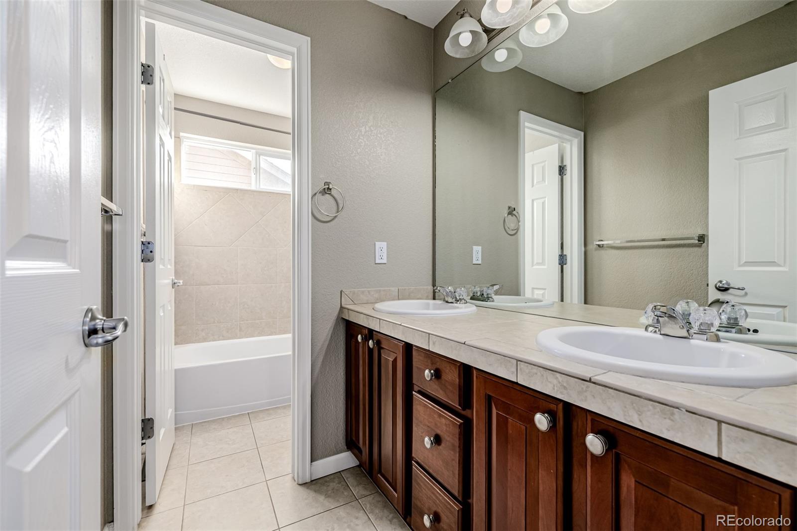 139 Muscovey Lane Johnstown, CO 80534 - Photo 24 of 49 a bathroom with a sink a vanity and a mirror