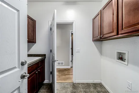 a kitchen with a sink a stove and cabinets