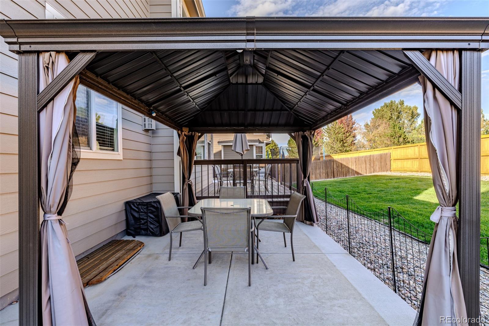 139 Muscovey Lane Johnstown, CO 80534 - Photo 34 of 49 a patio with wooden floor table and chairs
