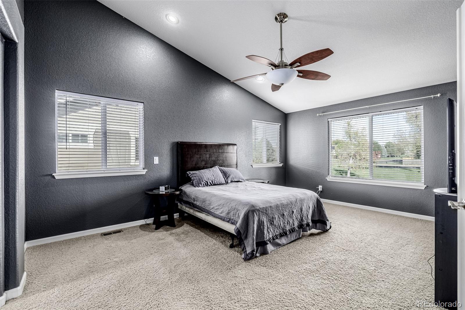 139 Muscovey Lane Johnstown, CO 80534 - Photo 47 of 49 a spacious bedroom with a bed chandelier and a window