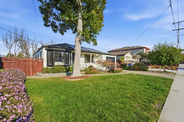 a front view of a house with a garden