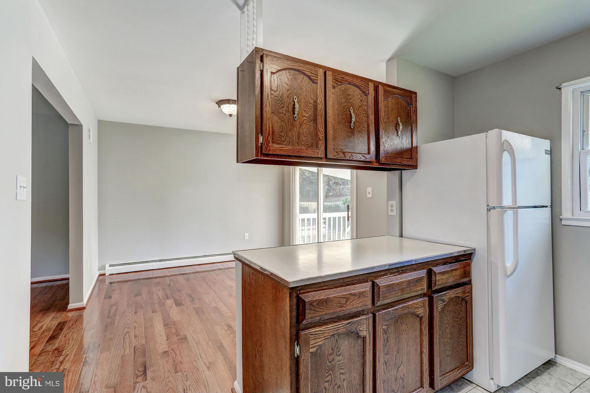 13818 Gilbert Road Woodbridge, VA 22193 - Photo 12 of 30 a kitchen with a refrigerator and a sink