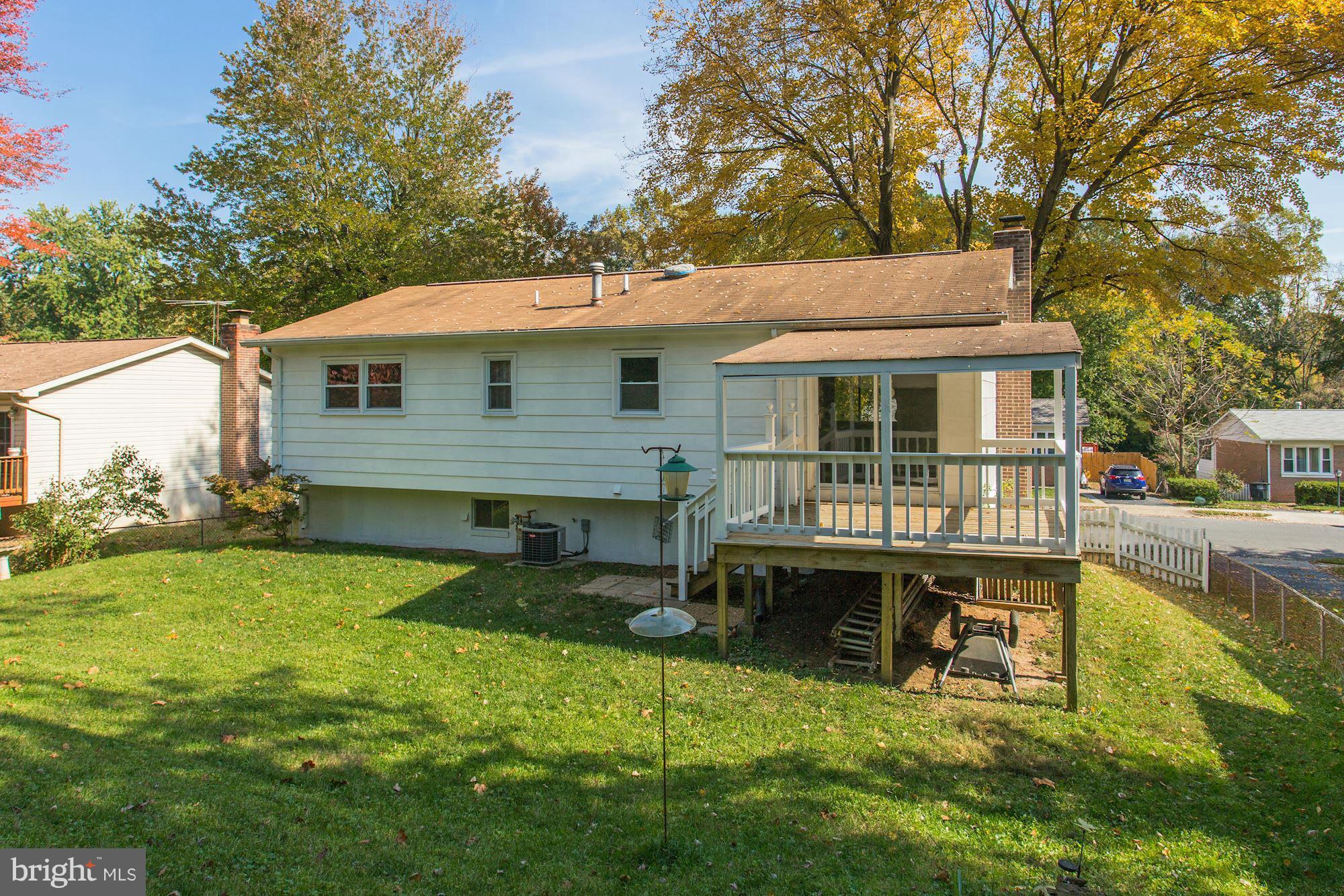 13818 Gilbert Road Woodbridge, VA 22193 - Photo 16 of 30 a view of a house with a yard patio and fire pit