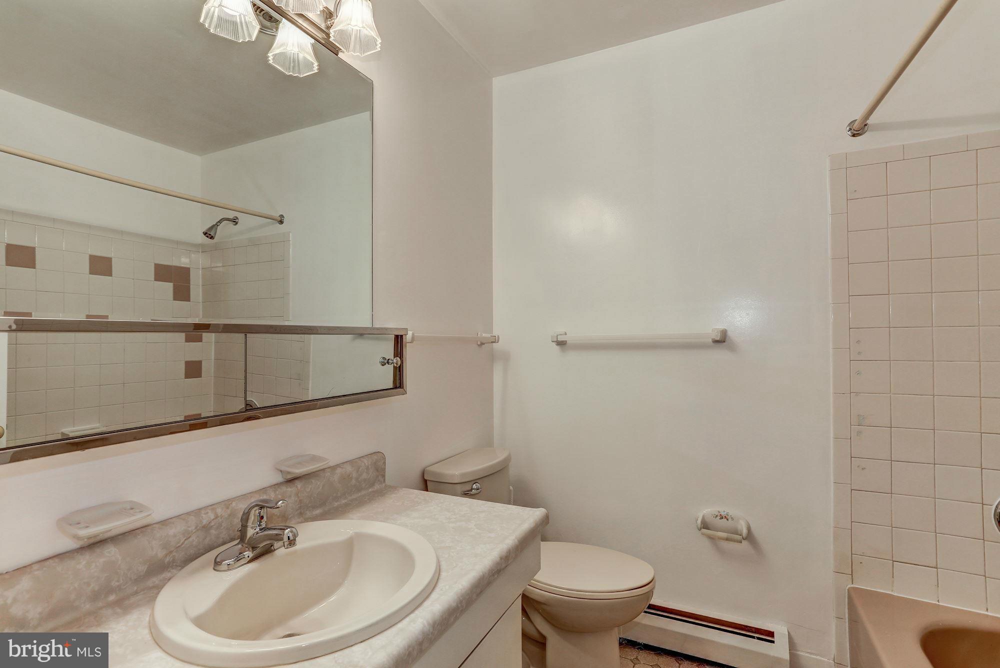 13818 Gilbert Road Woodbridge, VA 22193 - Photo 24 of 30 a bathroom with a sink a toilet and shower