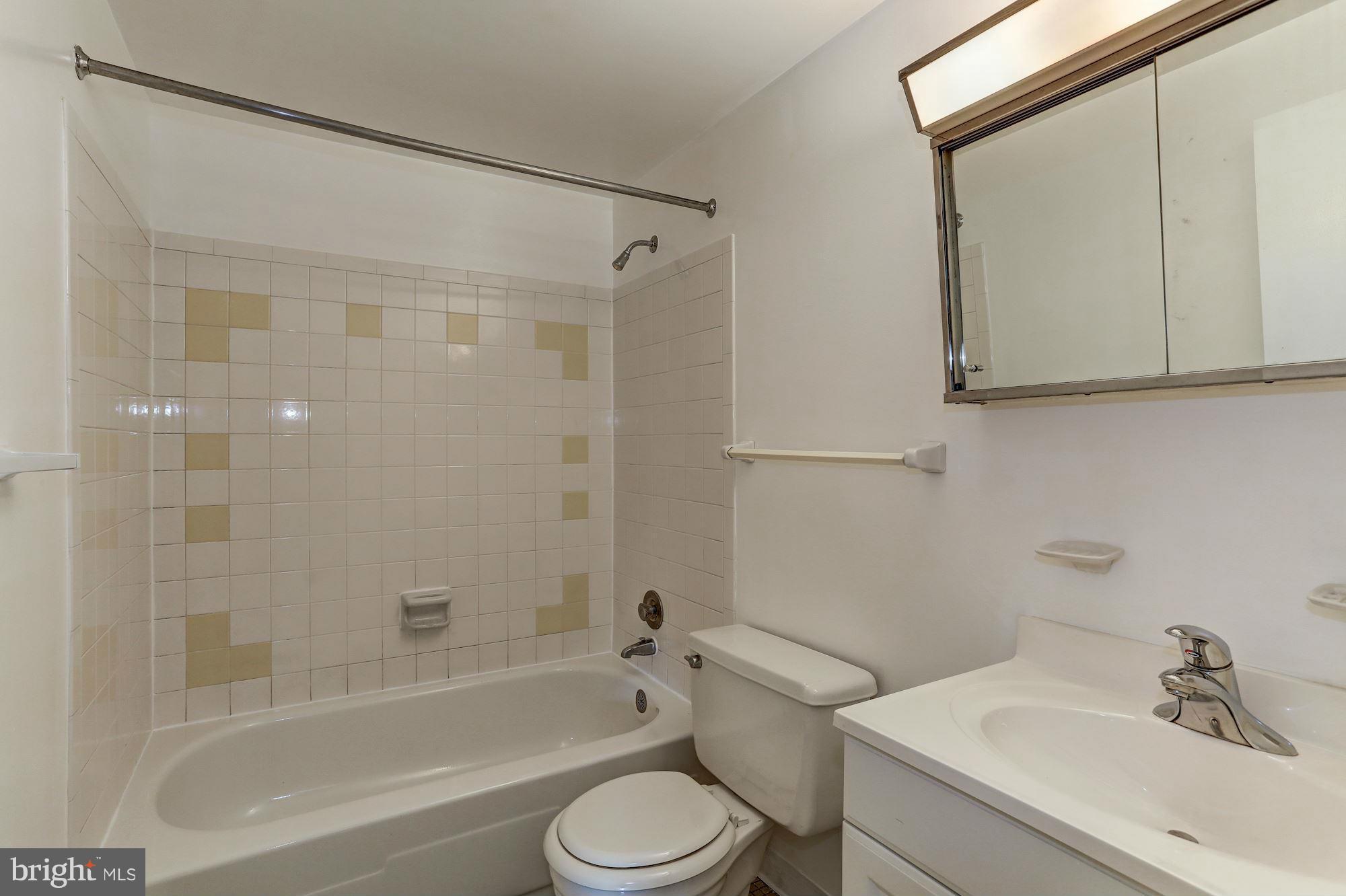13818 Gilbert Road Woodbridge, VA 22193 - Photo 28 of 30 a bathroom with a sink toilet and shower